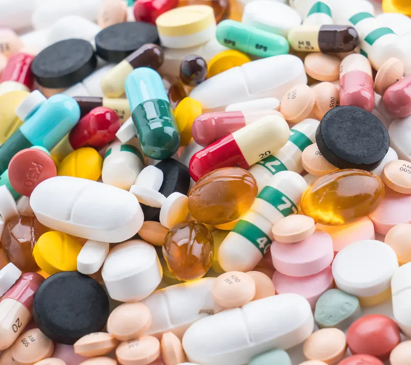 A pile of coloured capsules and tablets
